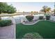 Lush backyard with artificial turf and serene views of the surrounding golf course at 2635 N 62Nd St, Mesa, AZ 85215