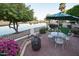 Inviting patio view with brick pavers, patio seating, and a lush green space at 2635 N 62Nd St, Mesa, AZ 85215