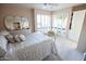 Bedroom features a queen bed and access to the back patio through shuttered doors at 2635 N 62Nd St, Mesa, AZ 85215