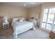 Bedroom features a queen bed, neutral colors and access to the backyard at 2635 N 62Nd St, Mesa, AZ 85215