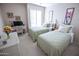 Comfortable bedroom offers two beds, a desk, and a light-filled window with shutters at 2635 N 62Nd St, Mesa, AZ 85215