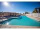 Spacious community pool with clear blue water, surrounded by a fence and a covered area at 2635 N 62Nd St, Mesa, AZ 85215