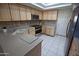 Bright kitchen features stainless steel appliances, light wood cabinets and tile flooring at 2635 N 62Nd St, Mesa, AZ 85215