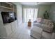 Sitting room features a comfortable sofa, television, and shuttered doors at 2635 N 62Nd St, Mesa, AZ 85215