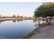 Scenic community pond reflects trees and nearby houses under a clear sky at 2635 N 62Nd St, Mesa, AZ 85215