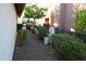 Gravel side yard with lush bushes, foliage, and a glimpse of the home's exterior at 2635 N 62Nd St, Mesa, AZ 85215