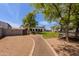 Spacious backyard showcasing a lush lawn, mature trees, and convenient pathway creating a serene and inviting outdoor space at 28061 N Holly Rd, San Tan Valley, AZ 85143