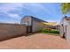 Gravel backyard with an enclosed play area including play structures and sunshade at 28061 N Holly Rd, San Tan Valley, AZ 85143