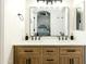 Bathroom features dual sink vanity with wood cabinets, modern fixtures, and large mirror at 28061 N Holly Rd, San Tan Valley, AZ 85143