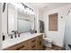 Bright bathroom with double sinks, modern fixtures, and natural wood cabinetry, offering a clean and functional design at 28061 N Holly Rd, San Tan Valley, AZ 85143