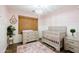 Bedroom features wood floors, a window and ample furniture at 28061 N Holly Rd, San Tan Valley, AZ 85143