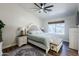 Bright bedroom with a large window, decorative rug, and overhead ceiling fan at 28061 N Holly Rd, San Tan Valley, AZ 85143