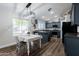 Eat-in kitchen with modern lighting, dark cabinetry, and stainless appliances at 28061 N Holly Rd, San Tan Valley, AZ 85143