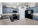 Stylish kitchen featuring stainless steel appliances, gray cabinets and neutral countertops at 28061 N Holly Rd, San Tan Valley, AZ 85143