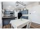 Bright eat-in kitchen features dark cabinets and modern lighting fixture at 28061 N Holly Rd, San Tan Valley, AZ 85143