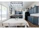 Bright eat-in kitchen with dark cabinets, stylish decor, and black appliances at 28061 N Holly Rd, San Tan Valley, AZ 85143