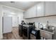 Well-equipped laundry room with modern washer, dryer, ice maker and stainless steel sink at 28061 N Holly Rd, San Tan Valley, AZ 85143