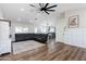 Bright living room with hardwood floors, ceiling fan, and a comfortable sectional sofa, creating a cozy atmosphere at 28061 N Holly Rd, San Tan Valley, AZ 85143