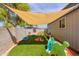 Backyard play area featuring artificial turf and shade, perfect for  at 28061 N Holly Rd, San Tan Valley, AZ 85143