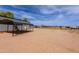 Large dirt property featuring multiple outbuildings and horse paddocks at 28061 N Holly Rd, San Tan Valley, AZ 85143