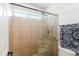 Tiled shower with glass door and bench at 28061 N Holly Rd, San Tan Valley, AZ 85143