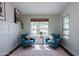 Cozy sitting room with stylish decor, featuring comfortable armchairs and natural light, creating a relaxing retreat at 28061 N Holly Rd, San Tan Valley, AZ 85143
