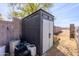 Outdoor storage shed with secure doors and a neutral color, providing ample storage space and complementing the landscape at 28061 N Holly Rd, San Tan Valley, AZ 85143