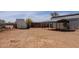 Large dirt yard with multiple buildings, showcasing the property's potential at 28061 N Holly Rd, San Tan Valley, AZ 85143