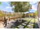 Landscaped backyard with modern grid-patterned lawn, desert plants, and outdoor seating area at 3025 W Sentinel Rock Rd, Phoenix, AZ 85086