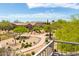 Scenic backyard view overlooking desert landscape with walking path and residential community beyond at 3025 W Sentinel Rock Rd, Phoenix, AZ 85086
