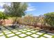 Well-maintained backyard with a modern grid-patterned lawn, desert plants, and decorative landscaping at 3025 W Sentinel Rock Rd, Phoenix, AZ 85086