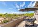 Serene balcony with an umbrella, seating, and scenic neighborhood views on a clear day at 3025 W Sentinel Rock Rd, Phoenix, AZ 85086