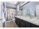 Charming bathroom with double vanity sinks, garden-themed shower curtain, and decorative wrought iron details at 3025 W Sentinel Rock Rd, Phoenix, AZ 85086