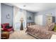 Comfortable bedroom features soft, blue walls and a cozy chair in the corner, alongside vintage decor at 3025 W Sentinel Rock Rd, Phoenix, AZ 85086