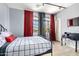 Comfortable bedroom with large windows, red and black curtains, and a stylish desk area with a telescope at 3025 W Sentinel Rock Rd, Phoenix, AZ 85086
