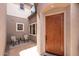 View of the entryway with a wooden front door and outdoor seating at 3025 W Sentinel Rock Rd, Phoenix, AZ 85086