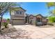 View of a home with a spacious driveway, mature trees, and desert landscaping at 3025 W Sentinel Rock Rd, Phoenix, AZ 85086