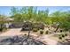 Attractive front exterior featuring well-kept desert landscaping, a two-car garage, and a neutral color palette at 3025 W Sentinel Rock Rd, Phoenix, AZ 85086