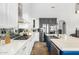 Modern kitchen featuring stainless steel appliances, white cabinets, and a central island sink at 3025 W Sentinel Rock Rd, Phoenix, AZ 85086