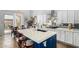 Bright kitchen with a white countertop island, gas range, and mirrored backsplash at 3025 W Sentinel Rock Rd, Phoenix, AZ 85086