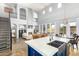 A grand living space with a fireplace, balcony, kitchen view, and multiple seating areas at 3025 W Sentinel Rock Rd, Phoenix, AZ 85086