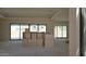 Well-lit living room with large windows and pre-built cabinetry throughout the home under construction at 3374 E Aquarius Ct, Chandler, AZ 85249