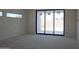 Unfinished room featuring a window and sliding glass doors, awaiting final touches at 3374 E Aquarius Ct, Chandler, AZ 85249