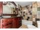This bathroom boasts a granite tile shower, custom vanity with dual sinks, and a large mirror at 3916 W Northview Ave, Phoenix, AZ 85051