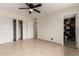 Spacious bedroom with closets, neutral walls, fan, and an adjacent bathroom at 3916 W Northview Ave, Phoenix, AZ 85051