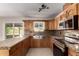 Kitchen features custom wood cabinets, granite countertops, stainless steel appliances, and tile floor at 3916 W Northview Ave, Phoenix, AZ 85051