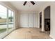 Bright living room with tile floors, closet, fan, and sliding glass doors leading to a pool at 3916 W Northview Ave, Phoenix, AZ 85051