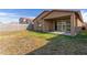 View of the back of the house and backyard featuring block wall fence and covered patio at 4050 W Coles Rd, Laveen, AZ 85339
