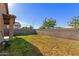 The backyard has a block wall fence, grass, and a tree at 4050 W Coles Rd, Laveen, AZ 85339