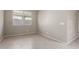 Neutral room showcasing a large window with tile flooring and natural light at 4050 W Coles Rd, Laveen, AZ 85339